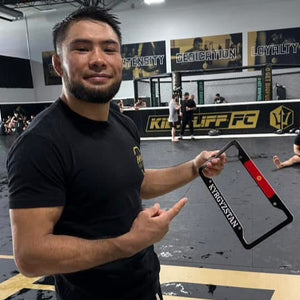Busurmankul Abdibait Uulu MMA Fighter holding Cultics frame