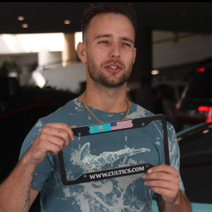 Cameron Clayton holding license plate frame with USA and Kazakhstan flag